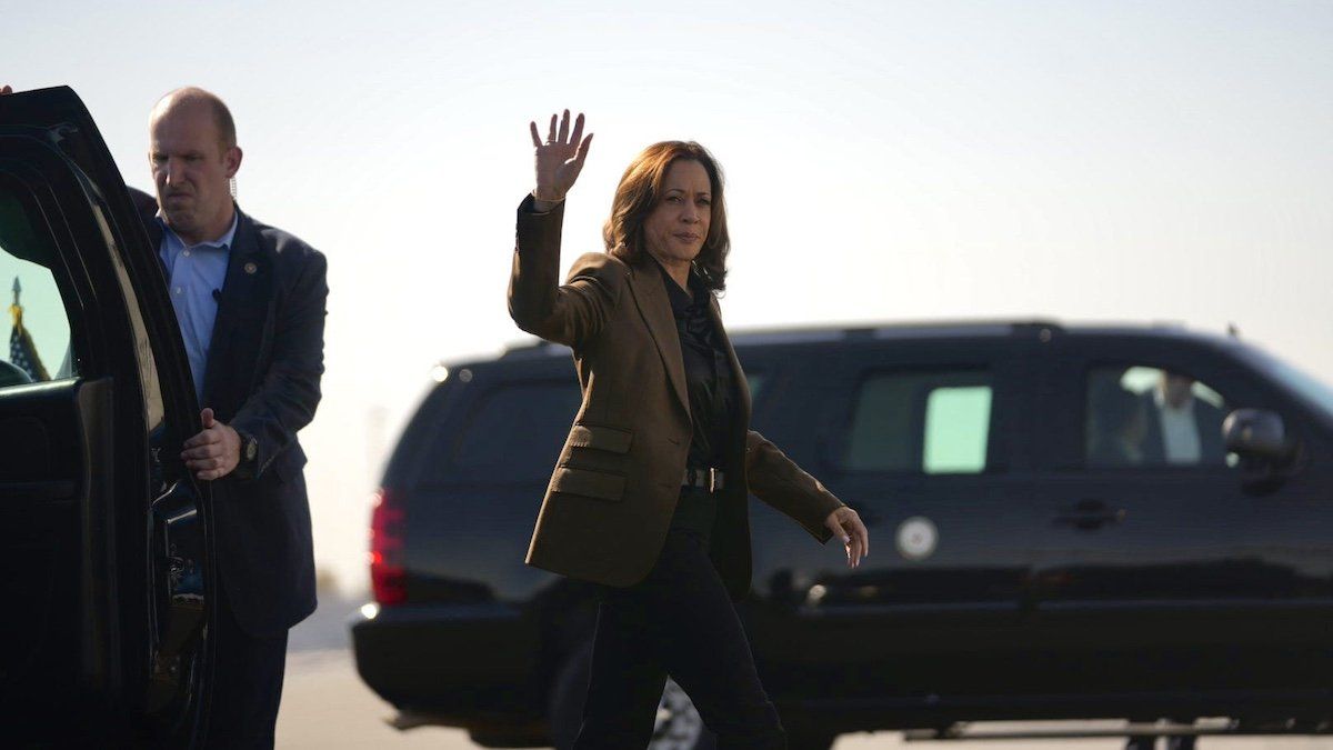 Vice President Kamala Harris waves to members of the media as she boards Air Force Two at Sky Harbor in Phoenix on Oct. 11, 2024.