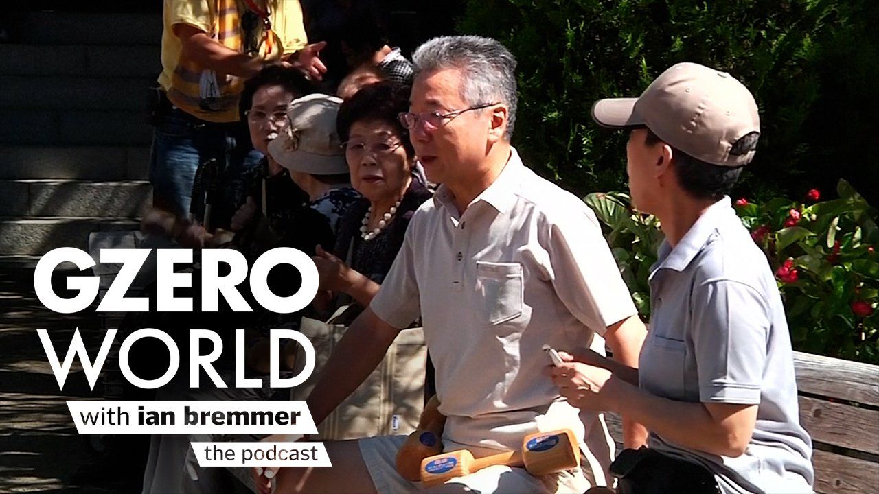 A photo of a old people sat on a bench outdoors and GZERO World with ian bremmer - the podcast